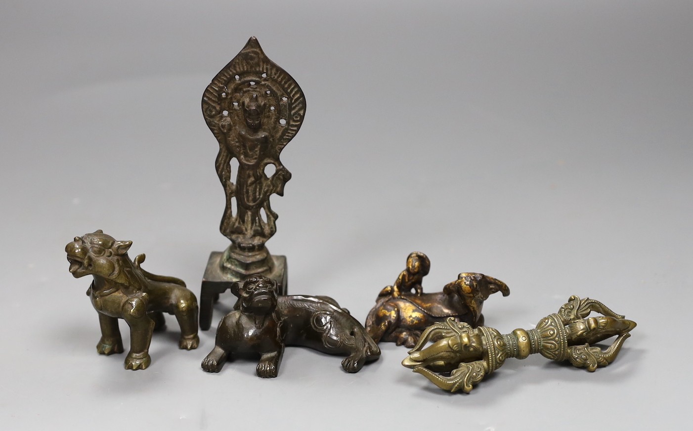 Five Chinese or Tibetan bronze figures or Buddhist implements, tallest 13cms high